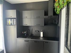 a kitchen with white cabinets and a counter top at BelleRive Love Room in Publier