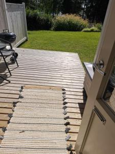 a wooden walkway leading to a yard with a door at Hirvikoto in Sotkamo +8 photos