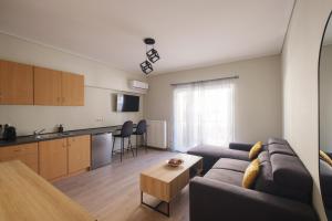 a living room with a couch and a kitchen at Tyto Alba Habitat in Athens