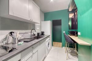 a kitchen with a sink and a washing machine at Cosy apartment - Near Paris - RER D in Villeneuve-Saint-Georges