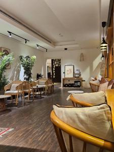 a living room with wooden chairs and tables at Duset Suites in Riyadh +62 photos