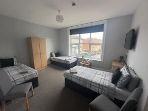 a room with a bedroom with a bed and a couch at The Prince Alfred Rooms in Liverpool