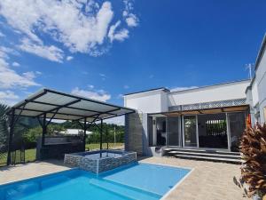 a villa with a swimming pool and a house at Villa Tokyo in Ibagué