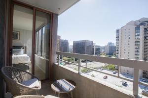 a balcony with two chairs and a view of a city at Spacious and Minimalist Apartment on Pentagon City in Arlington