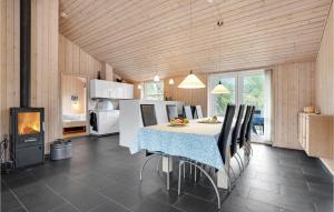 a kitchen and dining room with a table and chairs at Amazing Home In Ålbæk With Sauna in Ålbæk