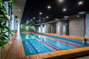 a large swimming pool in a building at Albatros Resort SPA in Ķesterciems
