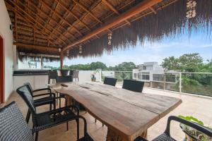 a wooden table and chairs on a patio at Casa Lula 5-BR Getaway in Riviera Maya in Playa del Carmen