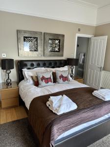 a bedroom with a large bed with two pillows at Alum Chine Beach House in Bournemouth