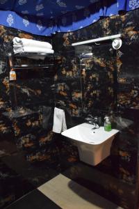 a bathroom with a sink and a stone wall at The Royal River Resort in Keonchi