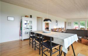 a kitchen and dining room with a table and chairs at Nice Home In Knebel With House Sea View in Knebel