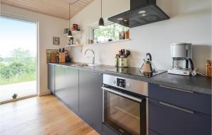 a kitchen with a sink and a stove at Nice Home In Knebel With House Sea View in Knebel