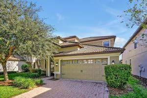 a large yellow house with a garage at Embrace Disney Magic at Our Luxe 6-BR Villa in ChampionsGate! in Davenport +87 photos