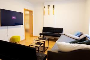 een woonkamer met een bank en een piano bij Bibo City Apartment in Bielefeld