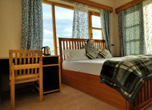 a bedroom with a bed and a window at Gawa Residency in Leh