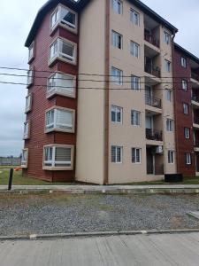 an apartment building on the side of a street at Departamento íntimo y de entorno natural. in Temuco