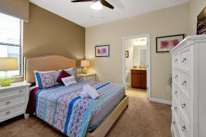 a bedroom with a bed and a bathroom at Embrace Disney Magic at Our Luxe 6-BR Villa in ChampionsGate! in Davenport