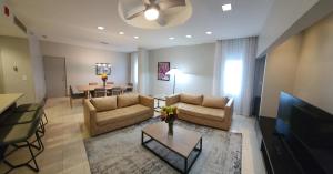 a living room with two couches and a dining room at Miami International Airport Hotel in Miami
