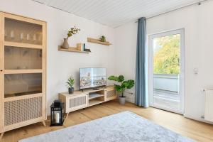 TV a/nebo společenská místnost v ubytování Charmante Wohnung in Waren by Nordic Homes