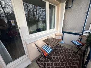 a porch with a bench and a window at Ferienwohnung NORDLICHT mit Balkon und Smart-TV in Rostock