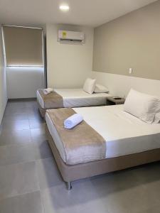 Hotel las Olas Yumbo客房内的一张或多张床位
