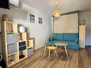 Una sala de estar con un sofá azul y una mesa. en Studio 4 couchages ARGELES SUR MER AR590-510, en Argelès-sur-Mer