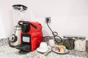 a red toaster sitting on top of a counter at Sunlit Orange Suite - TGV and Marina Access in Tangier