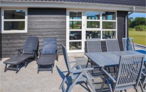 a picnic table and chairs on a patio at Holiday Home Fiskervej Sydals Denm in Skovby +18 photos