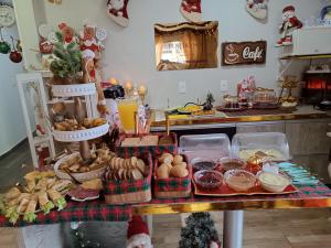 a table topped with lots of different types of food at Pôr-do-Sol Pousada in Penha