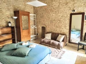 a living room with a bed and a couch at Casa Corte - Le Bouganville B&B in Lucera