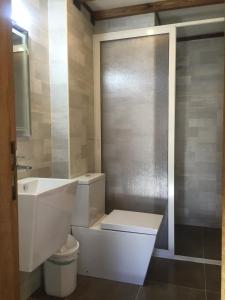 a bathroom with a toilet and a sink at CentreToni Arida in Al Arz