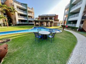 a table and chairs in front of a building at Terramaris - Paraíso Pé na areia in Aquiraz