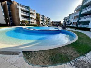 a large swimming pool in front of some buildings at Terramaris - Paraíso Pé na areia in Aquiraz +22 photos