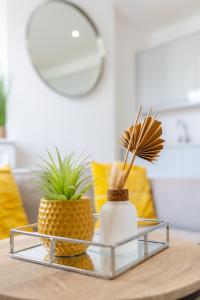 a coffee table with two pineapple vases on it at Boutique City Centre Apartments in Cardiff