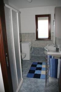 a bathroom with a sink and a toilet and a sink at Appartamenti Morena CIR 0043-CIR 0044 in Aosta