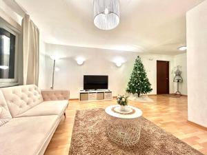 a living room with a couch and a christmas tree at K&A apartament in Haapsalu