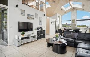 ein Wohnzimmer mit Sofa und Fernseher in der Unterkunft Gorgeous Home In Hvide Sande With Sauna in Bjerregård