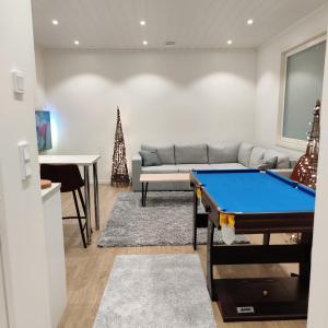 a living room with a pool table in it at Villa Hakala in Utajärvi