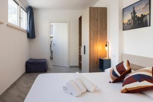 a bedroom with a white bed and a window at Sperlonga Center Holiday in Sperlonga +27 photos