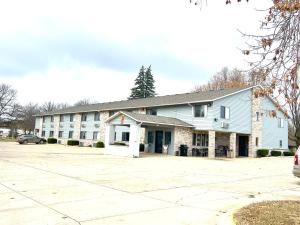 a large building with a parking lot in front of it at Super 8 by Wyndham Estherville in Estherville