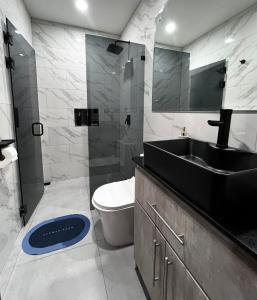 a bathroom with a sink and a toilet and a mirror at Mevak Apartments Suites in Fortuna +17 photos