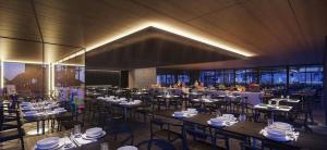 a dining room with tables and chairs in a building at Porto Alto Resort GAV em Muro Alto in Cupe
