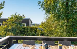 a balcony with a table and chairs on a deck at Three-Bedroom Holiday Home In Ebeltoft in Ebeltoft +24 photos