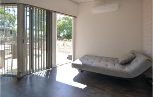 a couch sitting in a living room next to a door at Three-Bedroom Holiday Home In Ebeltoft in Ebeltoft