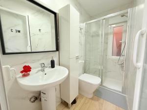 a white bathroom with a sink and a shower at Rosa House, Chalet 4 habitaciones y 4 baños in Pozuelo de Alarcón +35 photos