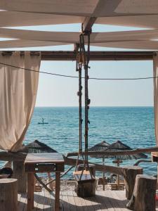 a view of the ocean from a beach with umbrellas at VivIglesias in Iglesias