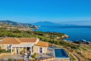a house with a view of the water at Villa Vardiola by Villa Plus in Skinária