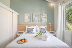 a bedroom with a bed with a plate of fruit on it at Villas Tangarane in Les Trois-Îlets