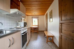 a kitchen with a sink and a stove top oven at Björnbyn Stugby in Råda