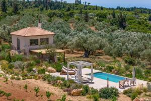 an image of a villa with a swimming pool and a house at Villa Idalia Retreat by Villa Plus in Koiliomenos