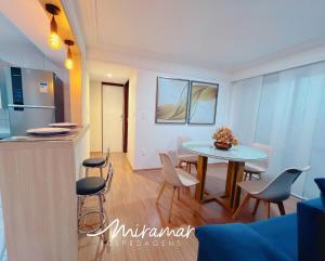 a kitchen and dining room with a table and chairs at Pontal Cabo Branco in Tambaú +56 photos
